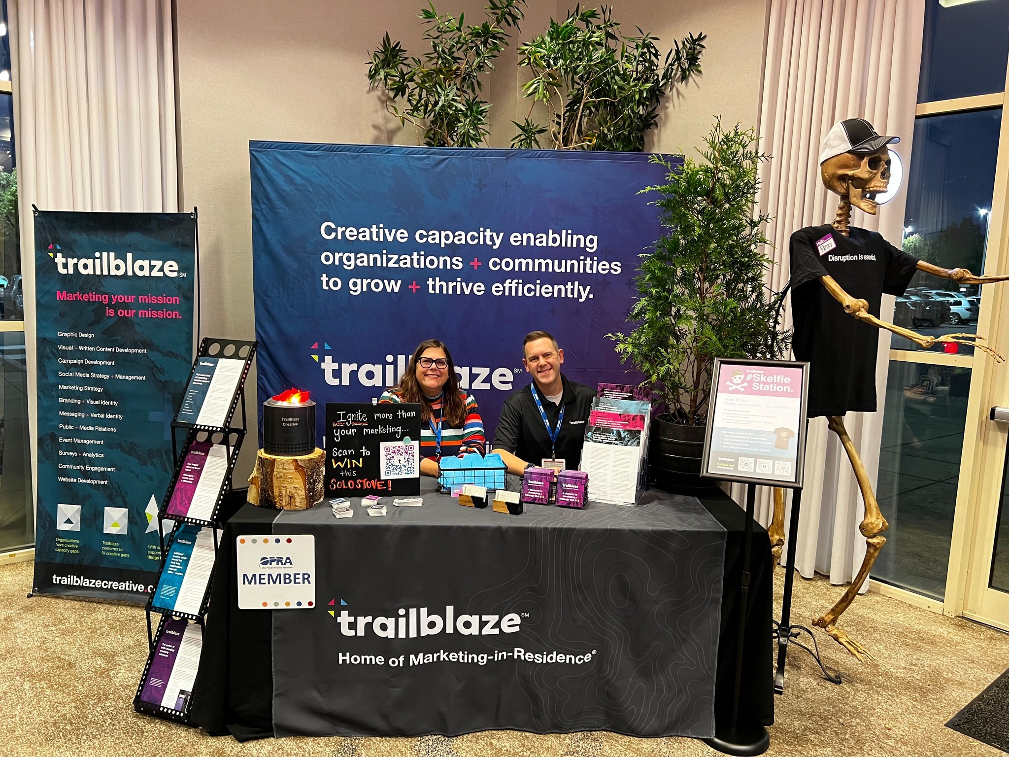 Tim Hindes and Erin Sogal sitting at TrailBlaze table.