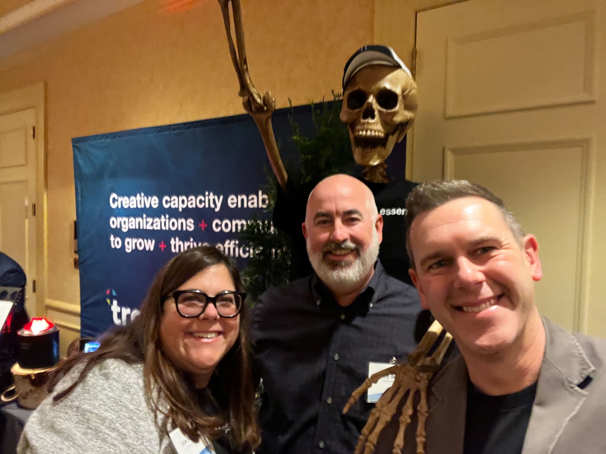 People smiling in front of tradeshow booth